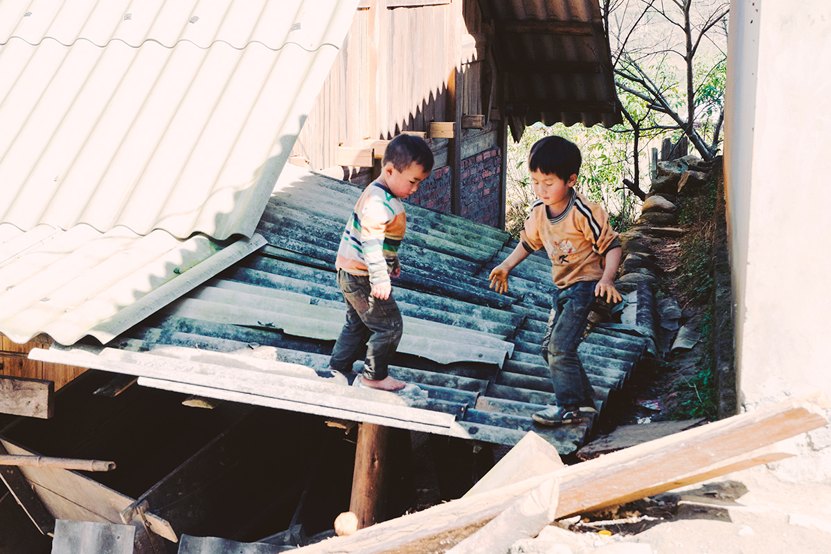 Children playing on a metal roof