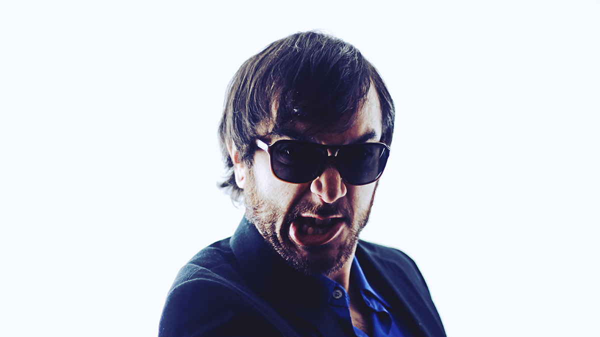 Elijah poses against a white studio background