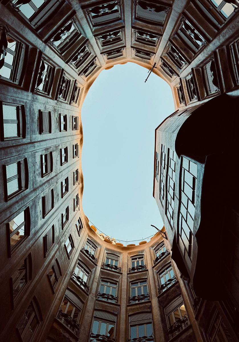 Looking up from a fully enclosed courtyard at Casa Milà